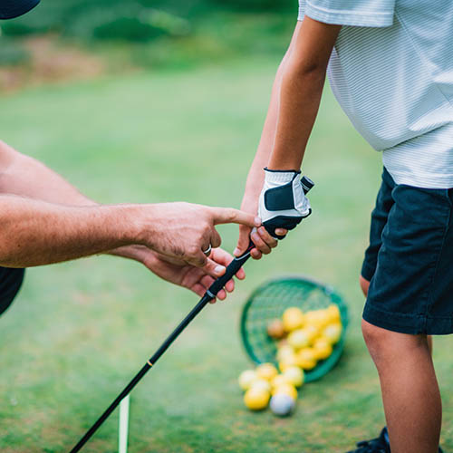 Father and child golfing